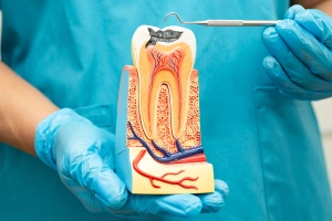 Man holding cheek in pain