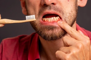 Man holding cheek in pain