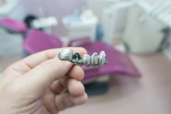 Man holding cheek in pain